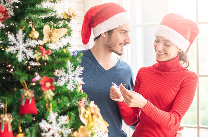 couple decorating christmas tree
