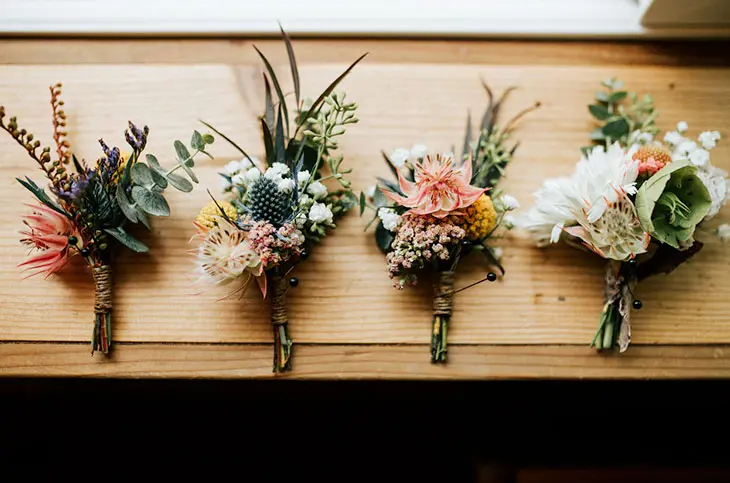 Four wedding lowers boutonnieres.