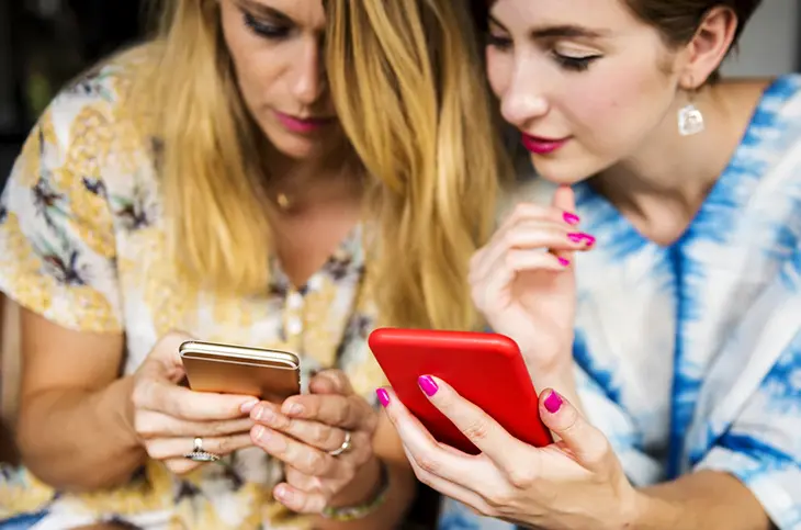 Two Women Holding Phones
