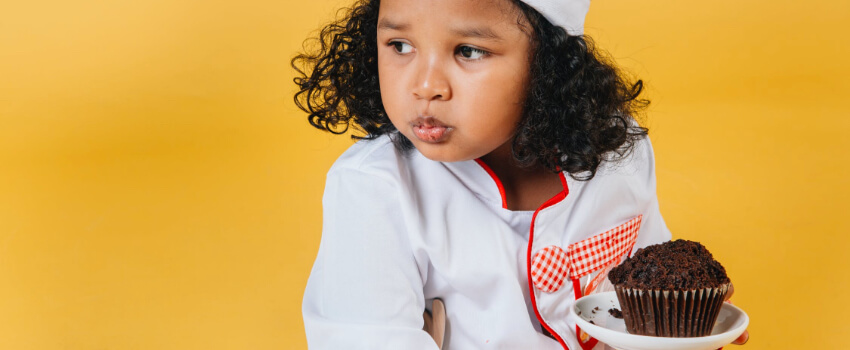 kid with a muffin in hand