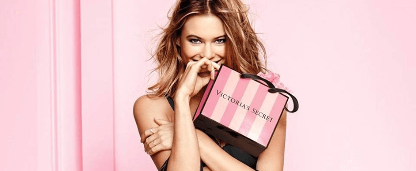 woman holding victoria's secret shopping bags