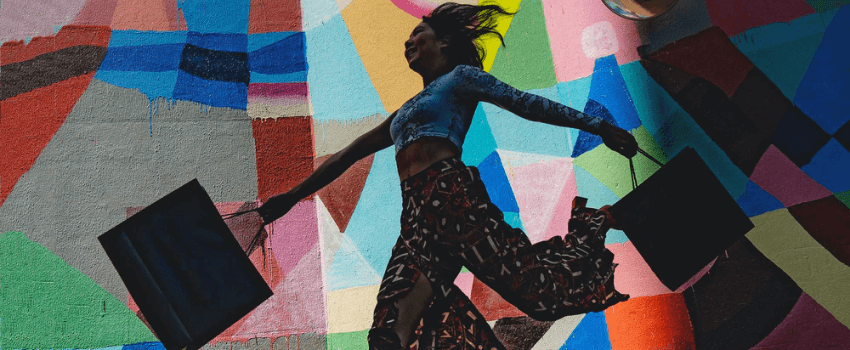 happy woman running with shopping bags in hands