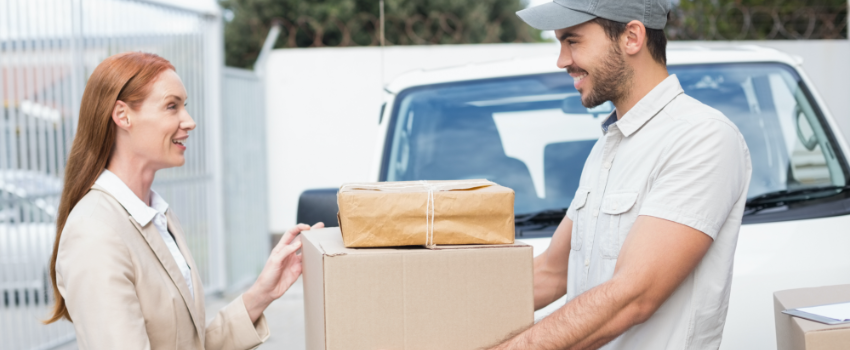 delivery man giving package to woman